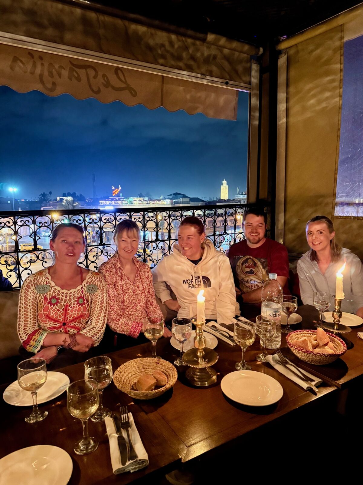 A group celebrates a successful Toubkal winter climb in Marrakech.