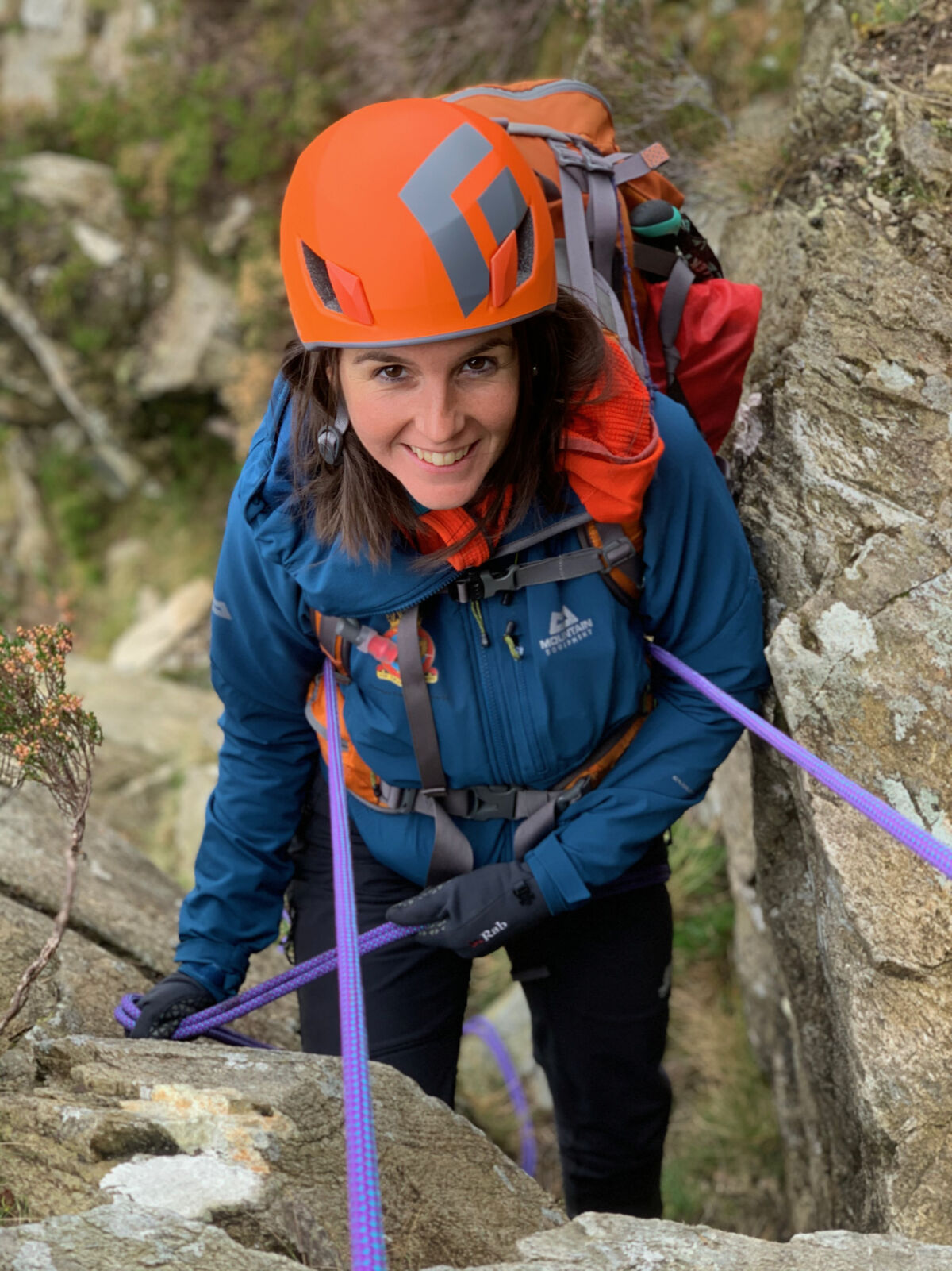 A woman abseils down Tryfan on a Mountain Leader assessment course.