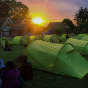 Tents set out in rows as the sunsets showing good Camping leader skills.