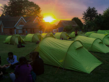 Tents set out in rows as the sunsets showing good Camping leader skills.