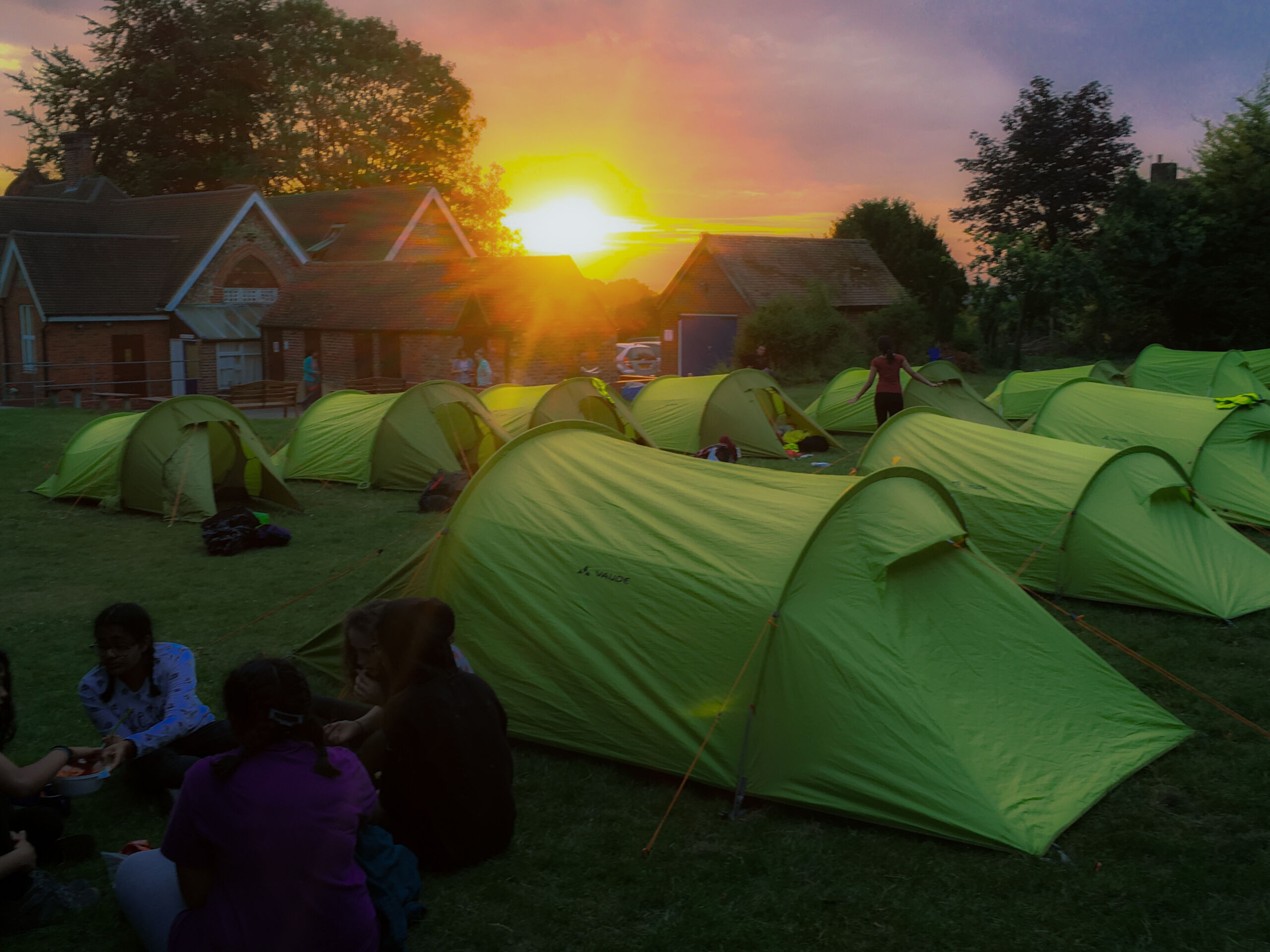 Tents set out in rows as the sunsets showing good Camping leader skills.