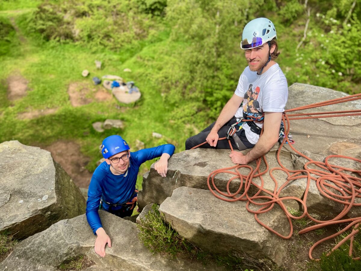 Two men learning to lead climb at Millstone Edge in the Peak District.
