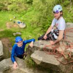 Two men learning to lead climb at Millstone Edge in the Peak District.