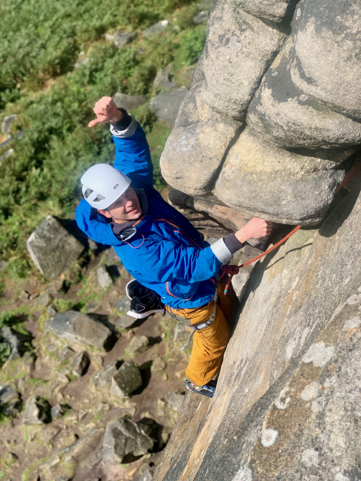 A man climbs a classic rock climb on Stanage