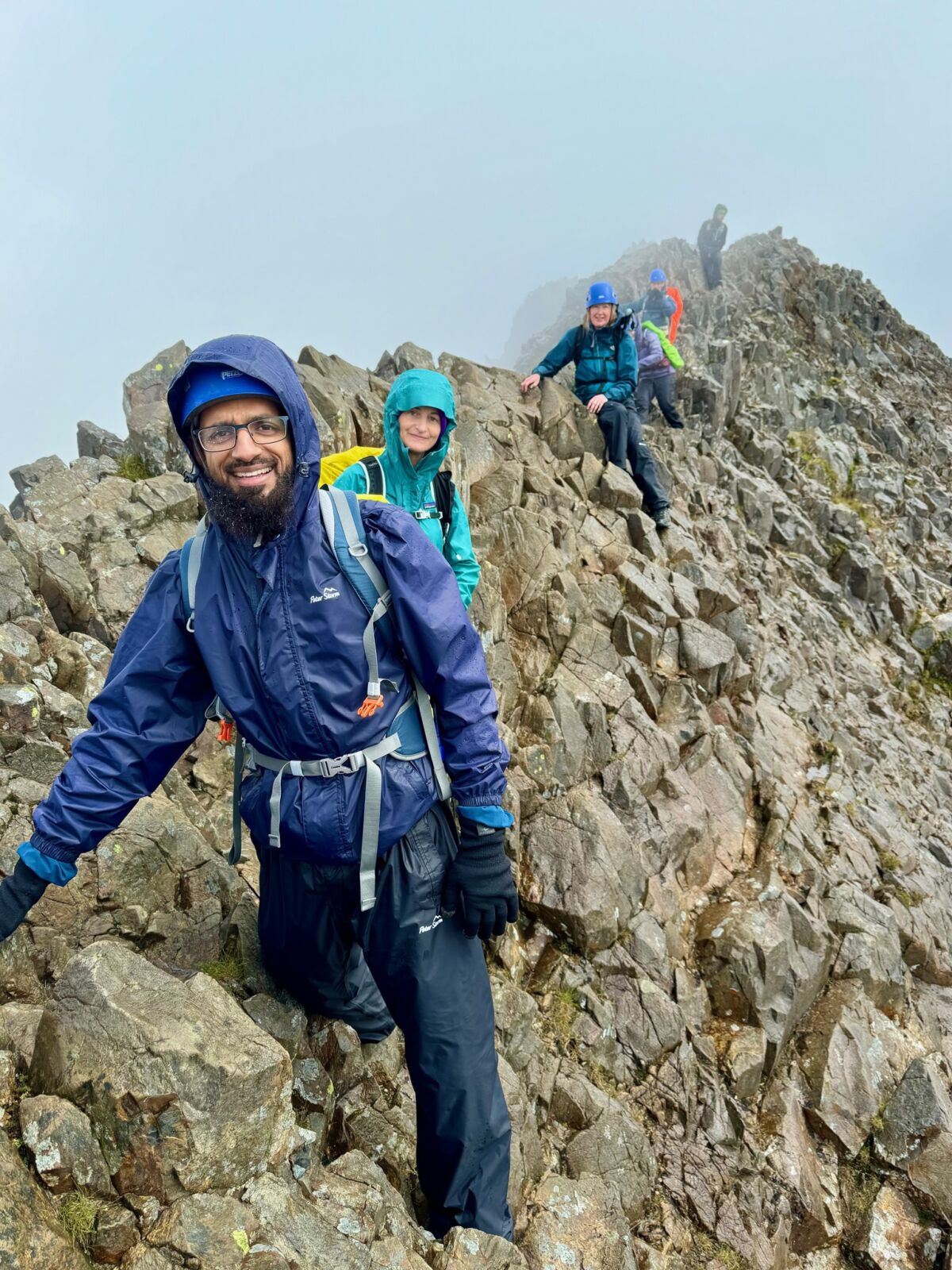 A group scrambling across Crib Coch ridge in Eryri whilst on a scrambling course with Beyond the Edge.