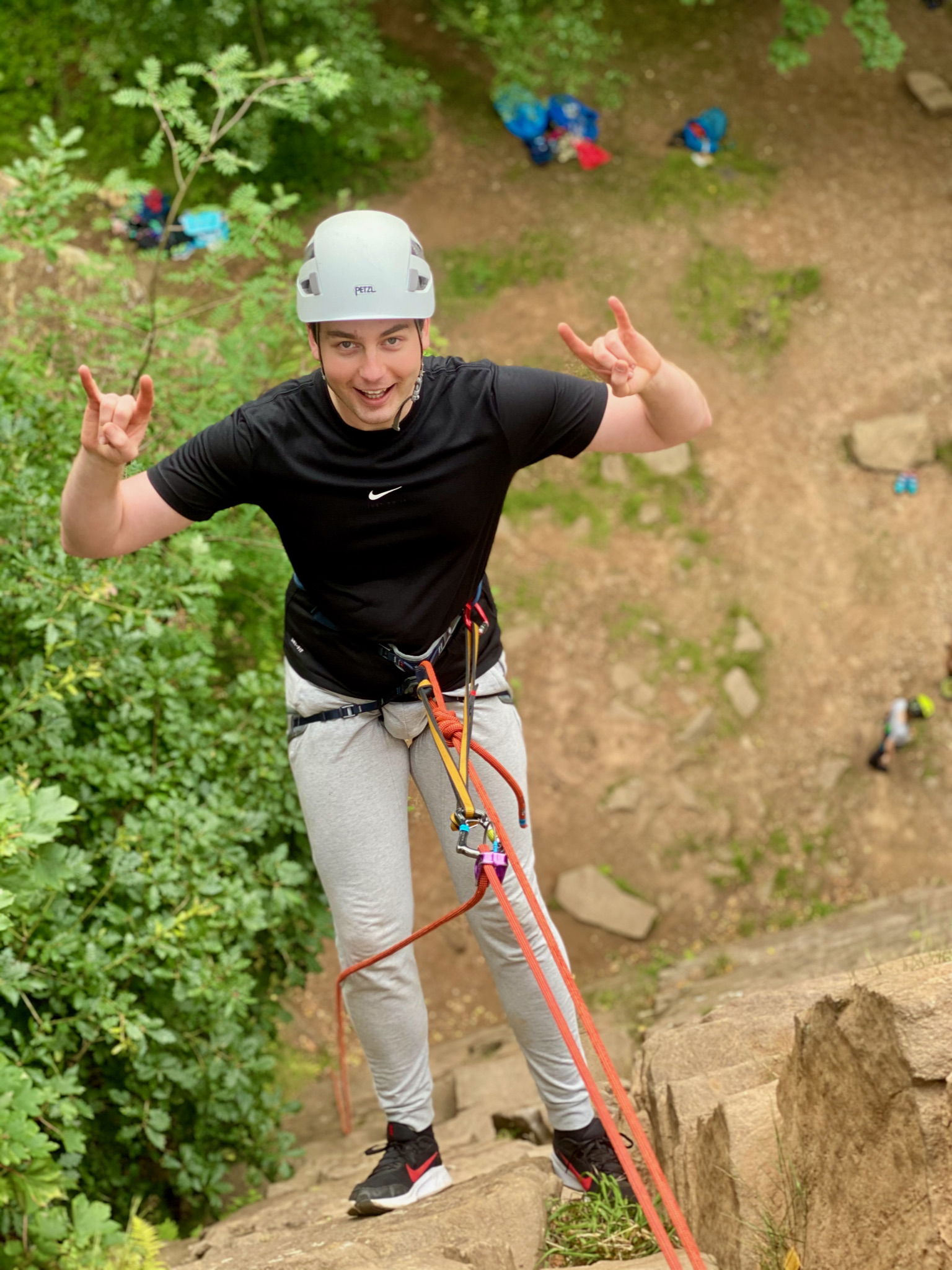 A man abseiling on an Introduction to rock climbing course in the Peak District.