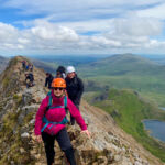 A group scrambling across Crib Coch ridge in Eryri whilst on a scrambling course with Beyond the Edge.