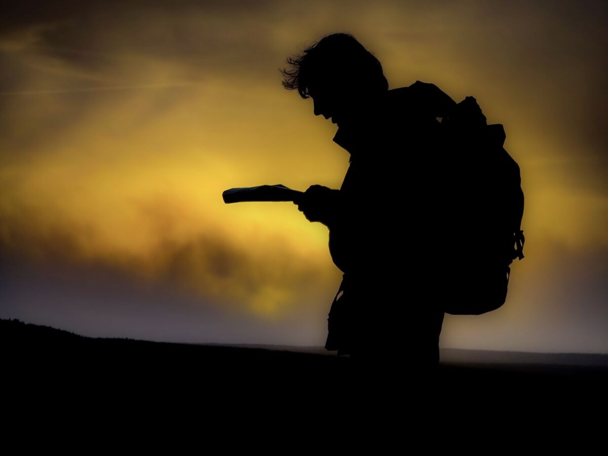 A man navigating with a map and compass on a Lowland leader course in the Peak District.
