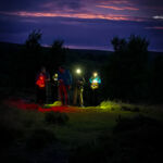 A group learning night navigation techniques on a Hill and Moorland Leader course in the Peak District.