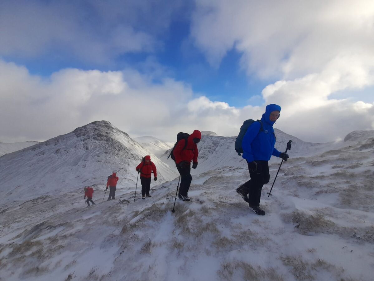 A group battle in strong winds on Buachille Etive Beag on an Introduction to Winter Mountaineering course.