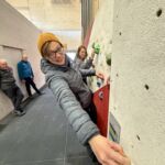 A lady practicing on a climbing wall instructor course in Sheffield.