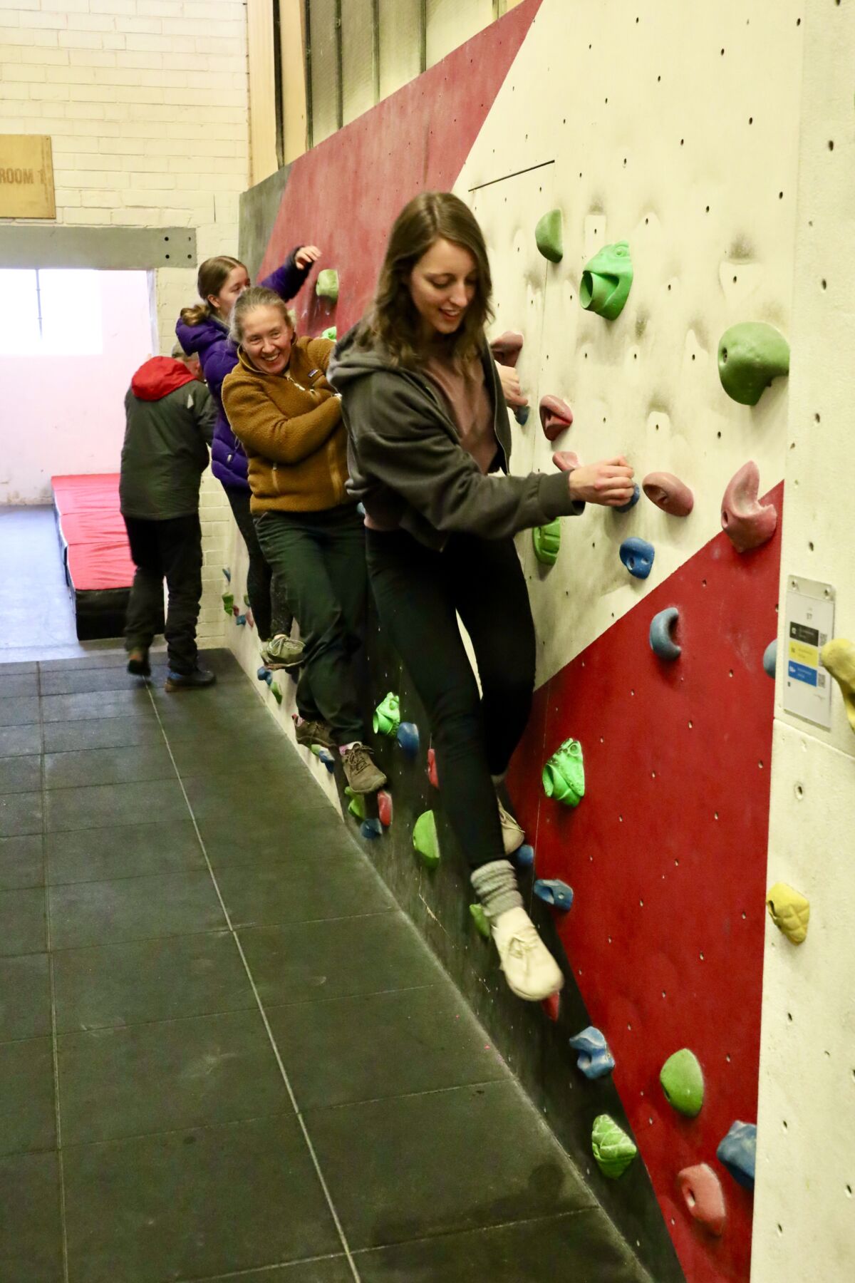 A group of ladies practicing on a climbing wall instructor course in Sheffield.