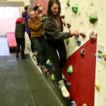 A group of ladies practicing on a climbing wall instructor course in Sheffield.