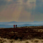 Two people navigating across moorlands whilst on a Hill and Moorland leader training course