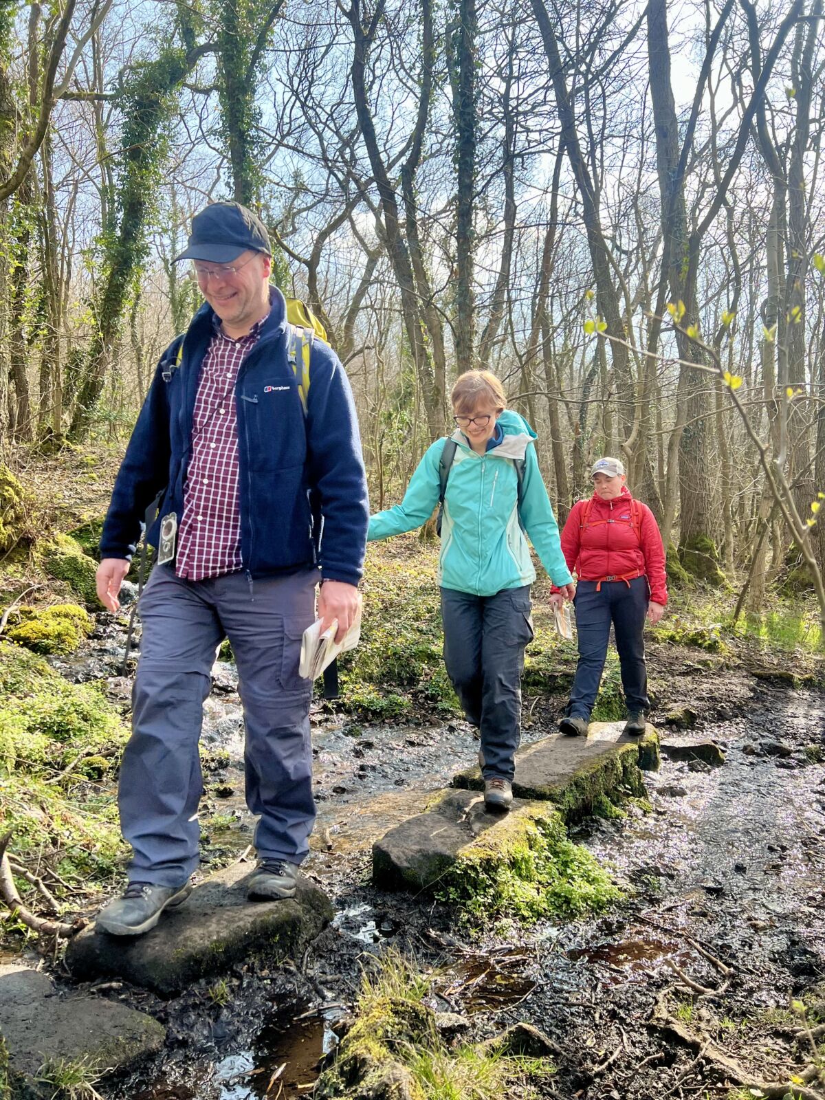 A group walk over stepping stones whilst on a Lowland Leader training course in the peak District.