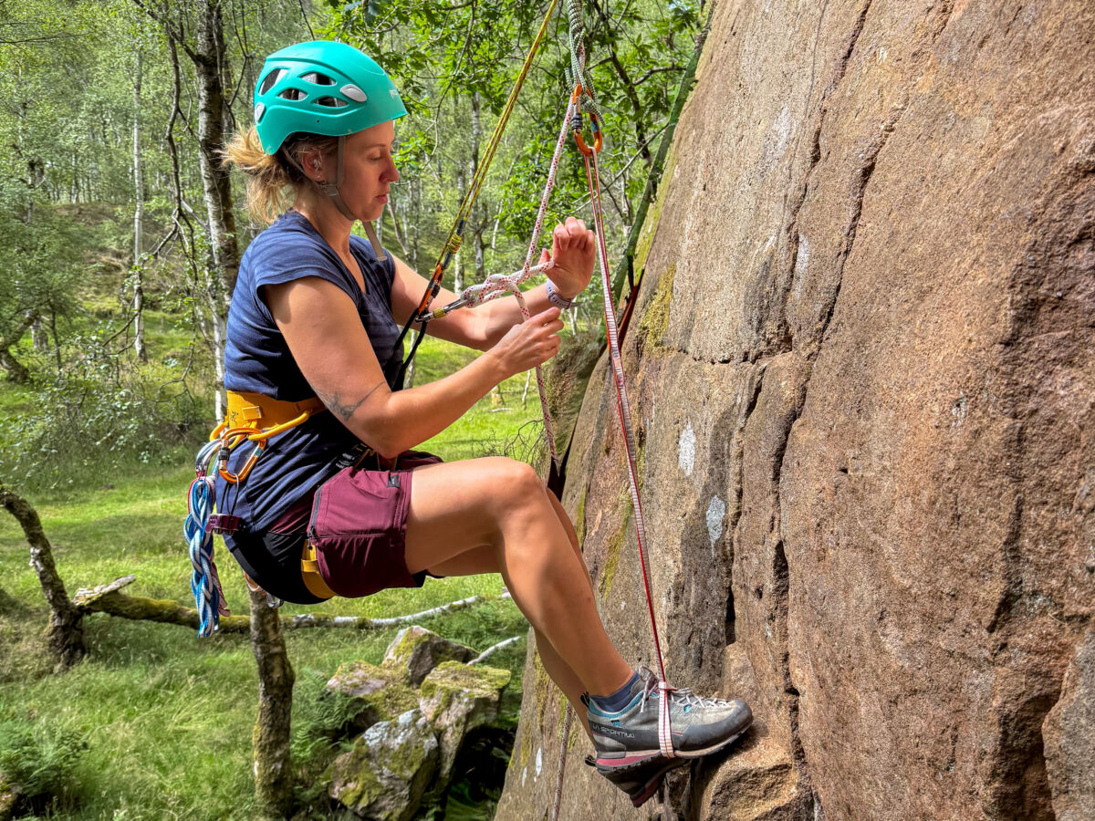 A rock climber problem solving and conducting improvised rescues on a course in the Peak District