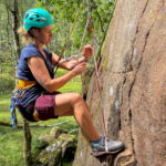 A rock climber problem solving and conducting improvised rescues on a course in the Peak District
