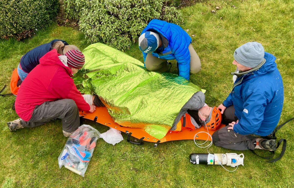 A group practicing advanced first aid in a complex medical scenario.