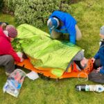 A group practicing advanced first aid in a complex medical scenario.