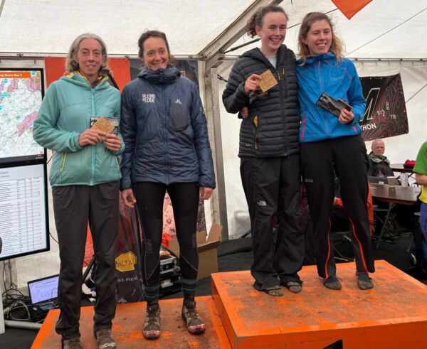 two women standing on the podium at a mountain marathon