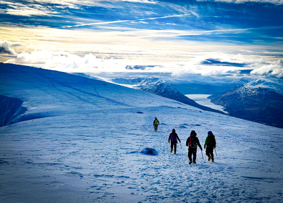 Descending at the end of a long and exciting day with snow lochs and clouds
