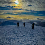 A group descending from the summit whilst on a winter mountaineering course in Scotland.