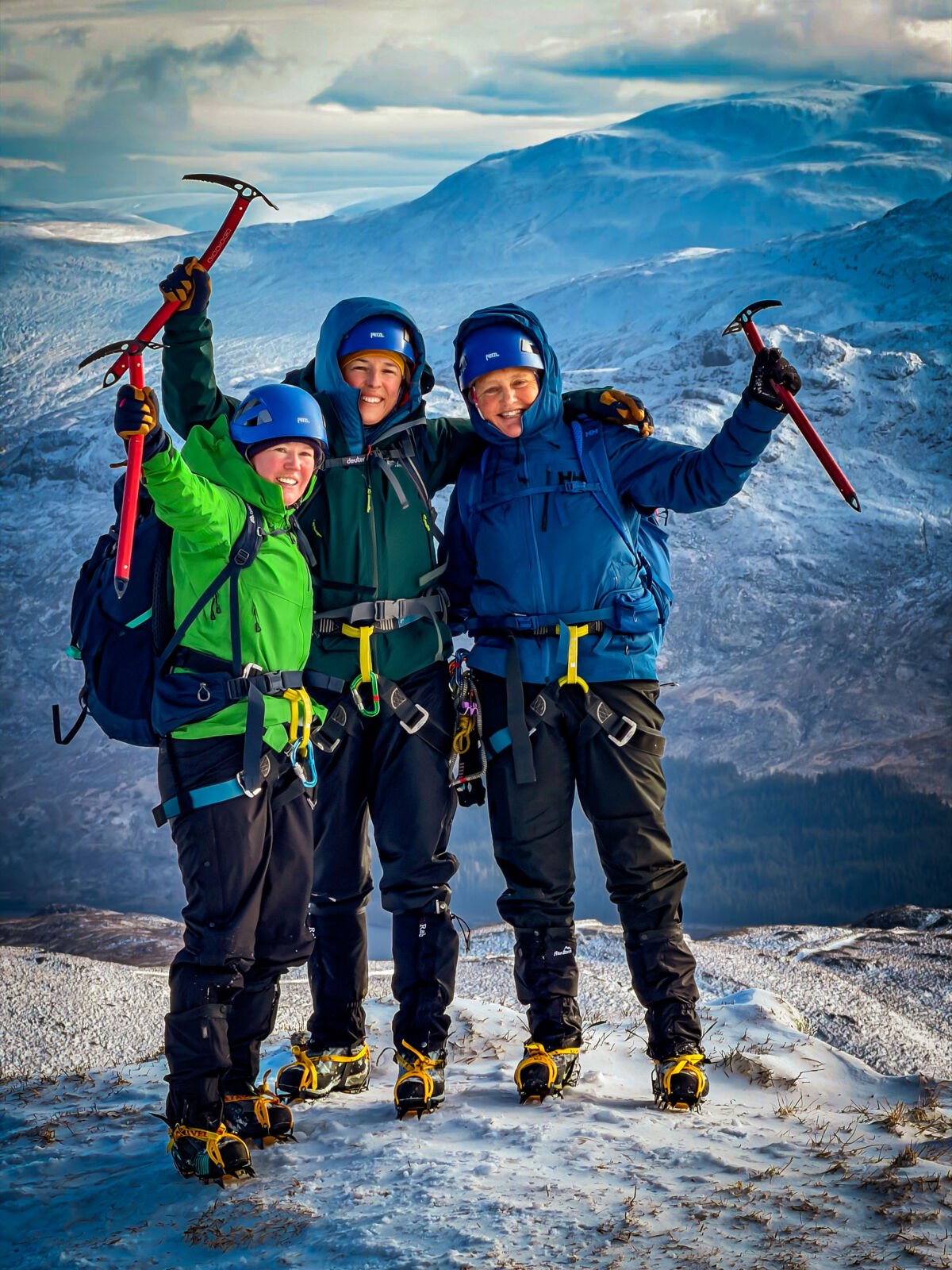 A group of ladies holding ice axes near the summit of Beinn a Chaoriann on a winter mountaineering course.
