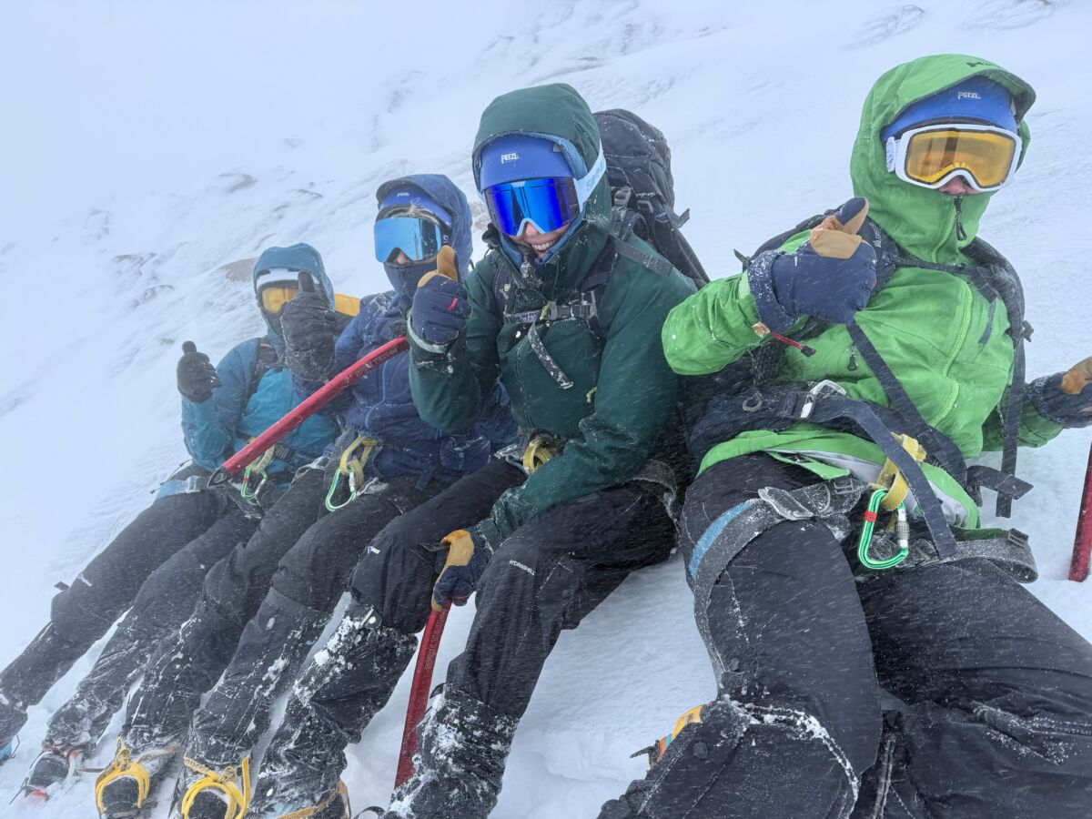 A group on steep snow whilst on a winter mountaineering course in Scotland.