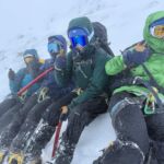 A group on steep snow whilst on a winter mountaineering course in Scotland.