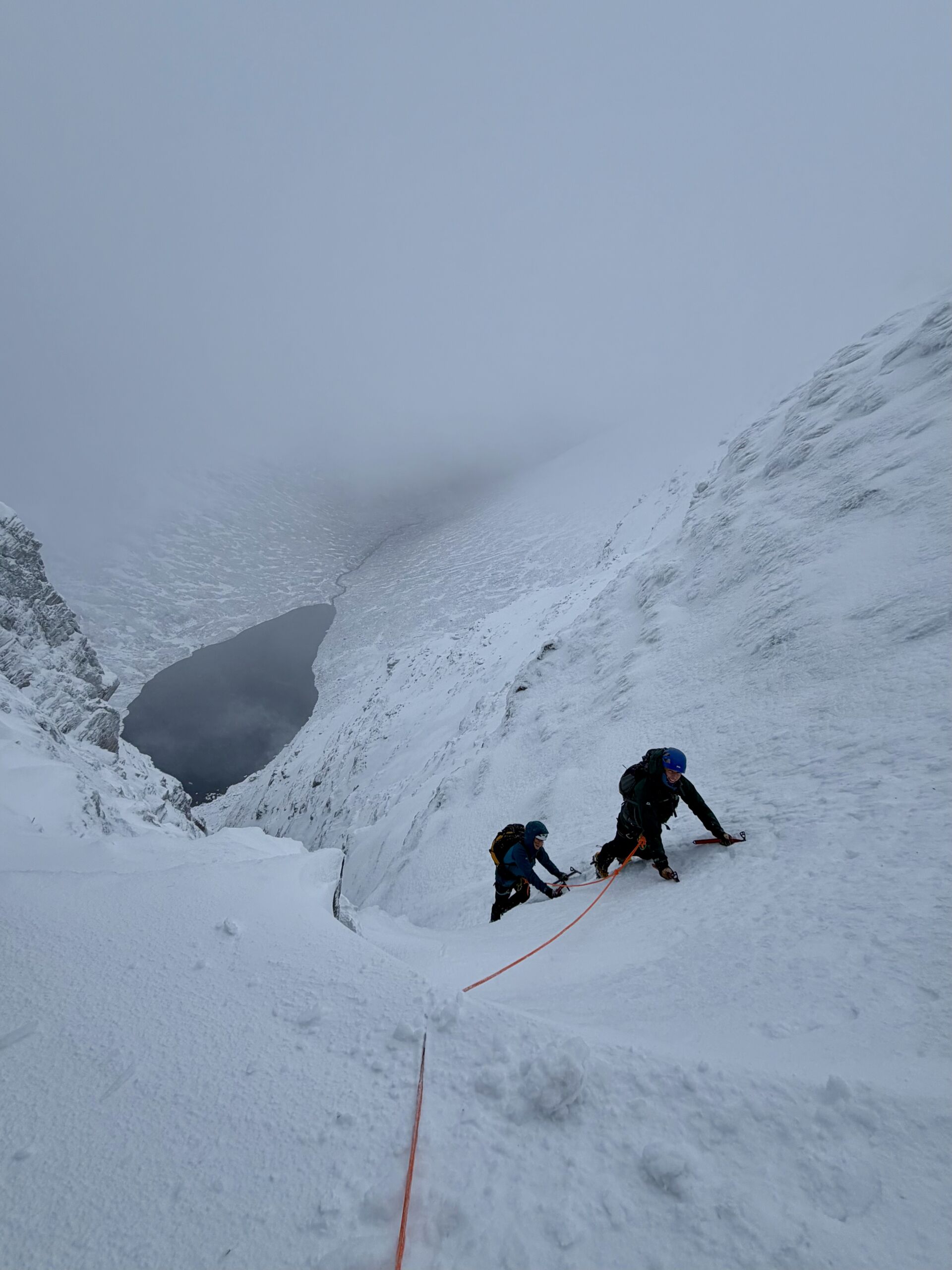 A pair of climbers in Raeburns gully on Creag Megadith whilst on a winter mountaineering course in Scotland.