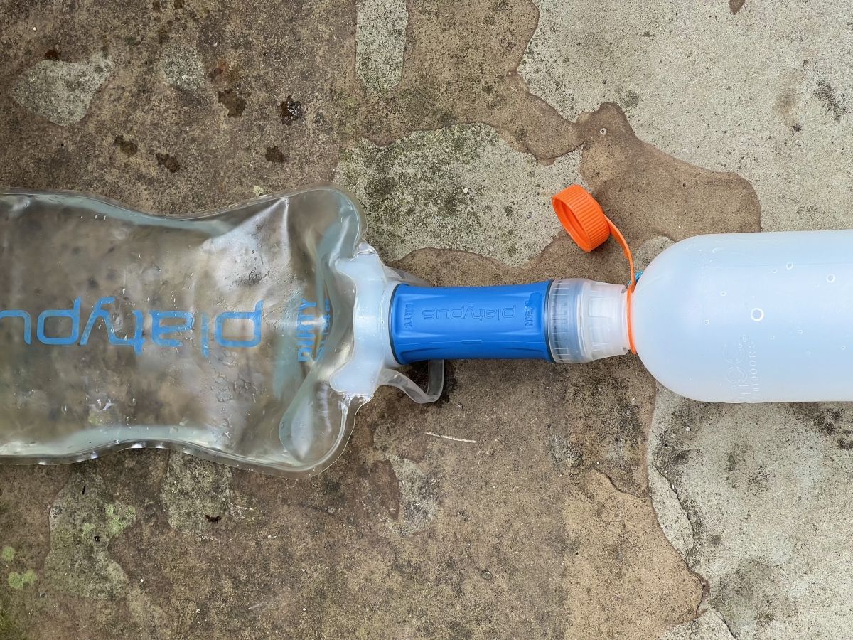 A blue Platypus Quickdraw water filter with water bottles attached 